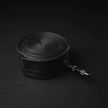 A rolled-up inner tube with its valve
