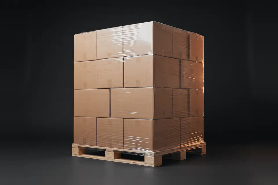 A stretch-wrapped pallet of plain shipping cartons